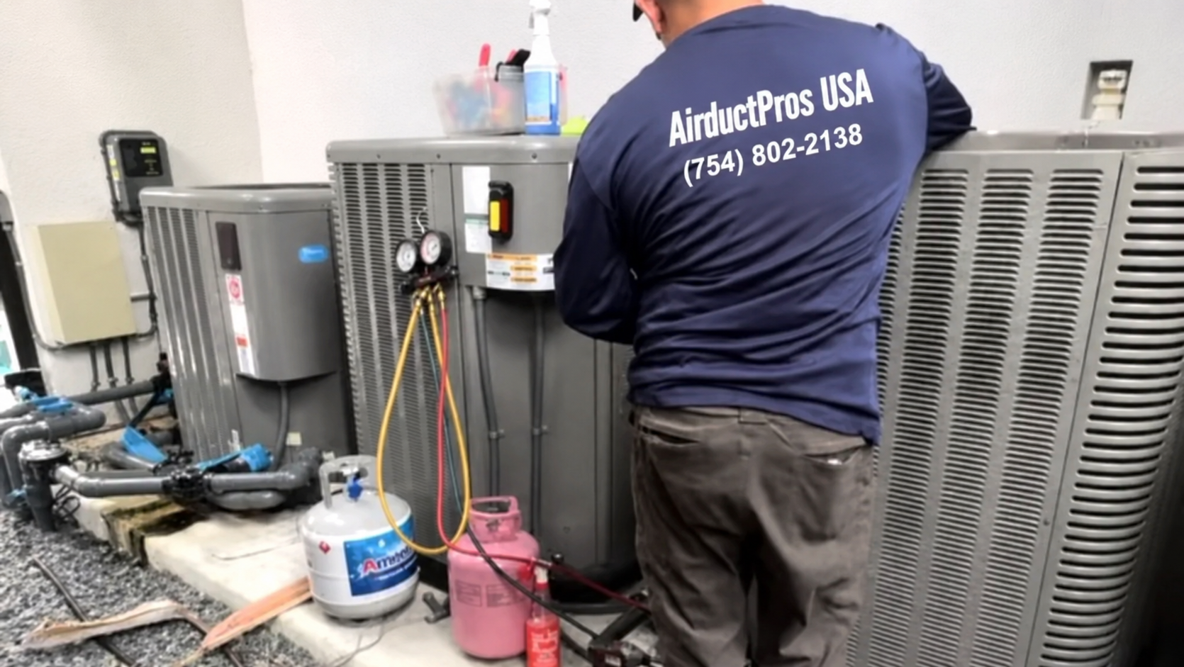 Air Duct Pros USA technician performing commercial AC repair on rooftop — Coral Gables Miami FL — full view